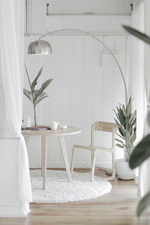 All white room with wooden table and chair